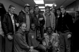 Men's basketball team with NCC Holiday Tournament trophy, St. Cloud State University