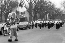 Marching band at the homecoming parade with Husky mascot, St. Cloud State University