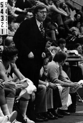 Noel Olson stands on the basketball court sidelines, St. Cloud State University