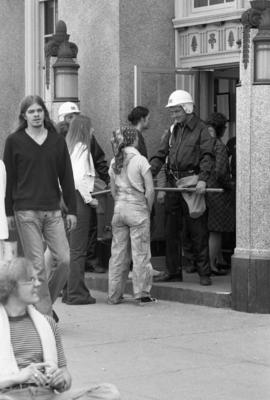 Policeman blocks entrance of building, Day of Peace protest, St. Cloud State University