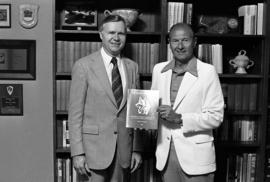 Charles Graham and John Kasper show off Kasper's book "The Husky Tradition : a History of Men's athletics at St. Cloud State University