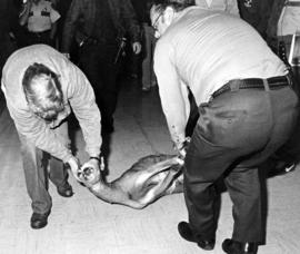 Two men remove a deer who ran through Stewart Hall (1948), St. Cloud State University