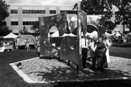 Charles Huntington and others stand in front of Perspectives artwork, Lemonade Concert and Art Fair, St. Cloud State University