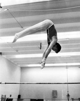 Gymnast John Fjellanger on the high bar, St. Cloud State University