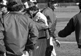 Players gather during a St. Cloud State University baseball game against Augsburg College