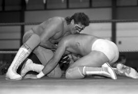 Wrestler Stinger grapples with Greg Gagne during a match at the Sauk Rapids High School