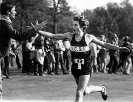 Runner Kurt Threinen finishes a race, St. Cloud State University, October 1983