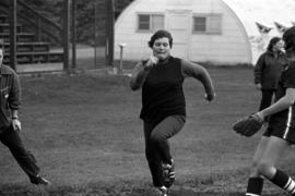 Woman softball player runs during a game against Winona State, St. Cloud State University