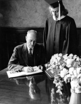 President Dudley Brainard signs the yearbook of Mary Lee Smith, St. Cloud State University