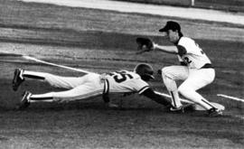 St. Cloud State University baseball players keeps an opposing runner close to first base