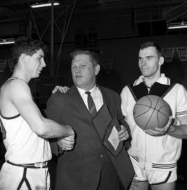 Two St. Cloud State basketball players congratulate Marlowe "Red" Severson on his 200th victory as St. Cloud State's men's head basketball coach