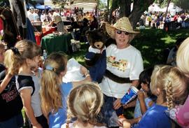 A woman and her puppet entertain children, Lemonade Concert and Art Fair, St. Cloud State University