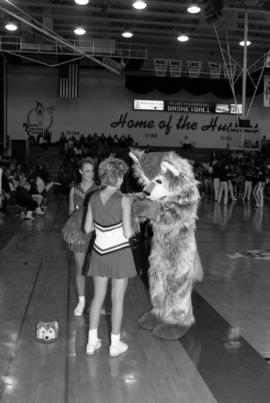 Husky mascot with two cheerleaders, St. Cloud State University