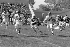 Football player Ken Neumann (#28) runs with the football against Winona State University