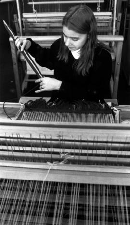 Sarah Opatz weaving on the loom in Kiehle, St. Cloud State University