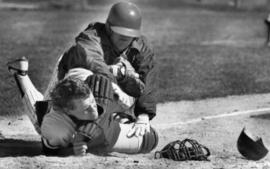 Baseball player Pete Pratt knocks over a catcher, St. Cloud State University