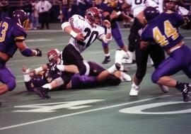 Randy Martin runs with a football during a game, St. Cloud State University