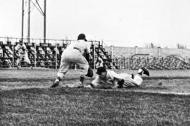 "Larry Vergin, Huskie pitcher, attempts to pick a man off first in a game at Municipal Stadium," St. Cloud State University