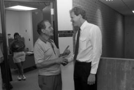 Newly hired SCSU head hockey coach Craig Dahl listens to an earful of advice given by Ludwig Andolsek who coached hockey at SCSU from 1933 to 1935, St. Cloud State University