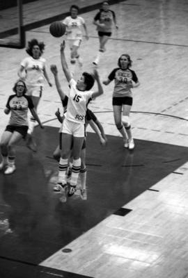 St. Cloud State University basketball player Sue Wahl shoots a basketball during a game with Dr. Martin Luther College