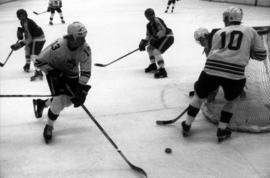 St. Cloud State hockey player Steve Martinson moves the puck around the hockey goal during a game with Iowa State University