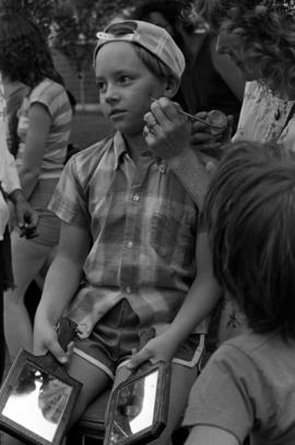 A boy gets his face painted, Lemonade Concert and Art Fair, St. Cloud State University