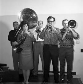 Men and women stand together playing musical instruments, St. Cloud State University