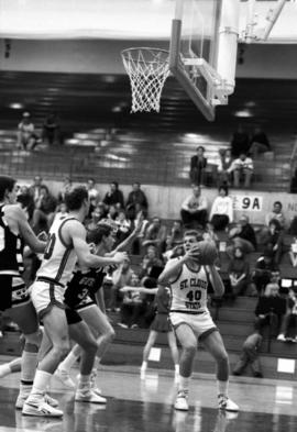 Basketball player Troy Rudoll grabs a basketball during a game against Gustavus Adolphus College, St. Cloud State University