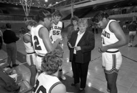 Basketball coach Gladys Ziemer talks to her players