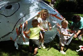 Children gather in front of a tent, Lemonade Concert and Art Fair, St. Cloud State University