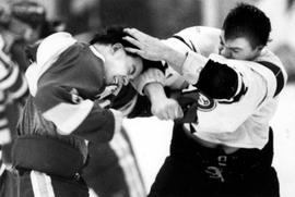 Hockey player Tony Schmalzbauer lands a punch on another hockey player, St. Cloud State University