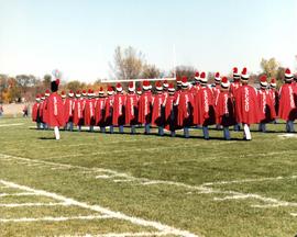 Marching band marches on a football field, St. Cloud State University