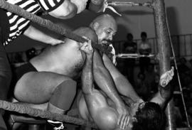 Wrestler Tom Lentz holds down Ricky Martel during their wrestling match at Halenbeck Hall (1965), St. Cloud State University