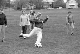 A woman kicks a soccer ball, St. Cloud State University