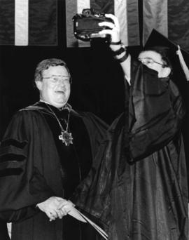 Robert Bess has his picture taken with aﾠ student at commencement, St. Cloud State University