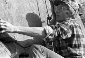 Man climbs up a cliff at the Taylors Falls State Park, St. Cloud State University