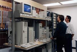 Phil Thorson and Tony Sorteberg look over computer equipment in Centennial Hall (1971), St. Cloud State University