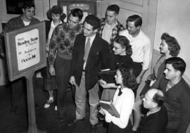 Students read a sign that the Old Model School (1906) reading room was full, St. Cloud State University