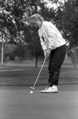 Kerry Brodt putts a golf ball, St. Cloud State University