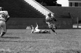 St. Cloud State football player Keith Nord runs with the football in a game against St. Thomas University