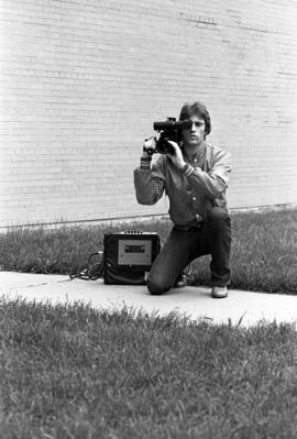 Man operates a portable camera, St. Cloud State University