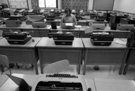 Student sits in typewriter room, St. Cloud State University