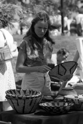 A woman looks at merchandise, Lemonade Concert and Art Fair, St. Cloud State University