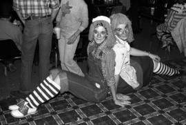 Two women sit together at the Halloween Hullabaloo, St. Cloud State University