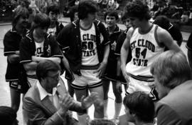 St. Cloud State University basketball coach Noel Olson talks to his players, including Dan Hagen, during a break in a game against Bemidji State University