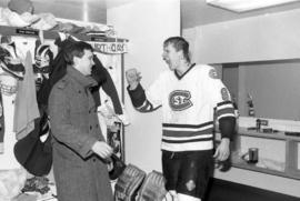 A hockey player celebrates in the locker room, St. Cloud State University