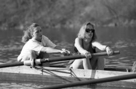 Rowing Club members sit in a boat rowing, St. Cloud State University