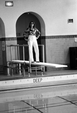 A woman stands on a diving board in the Eastman Hall (1930) pool, St. Cloud State University