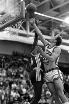 Basketball player Todd Spaulding jumps for a basketball during a game against Augustana College, St. Cloud State University