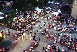 People gather on sidewalks to watch an orchestra perform, Lemonade Concert and Art Fair, St. Cloud State University